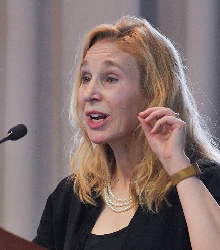 Dr. Sheena Josselyn speaks at podium in Neuroscience Center.