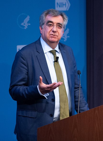 Collinge standing at podium