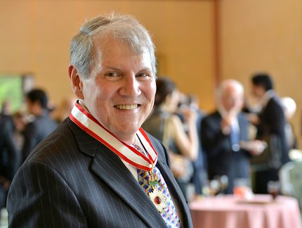 Katz wearing Rising Sun medal, with award reception in background