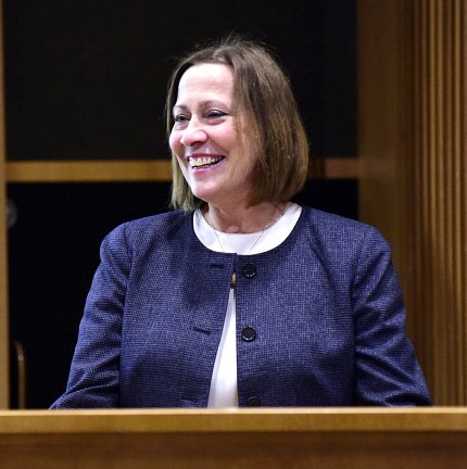 Dr. Louis at podium speaking 