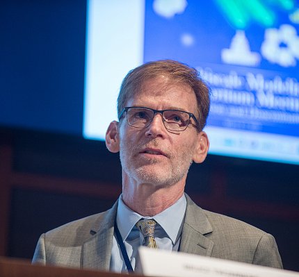 Closeup of Tromberg with slide projected behind him