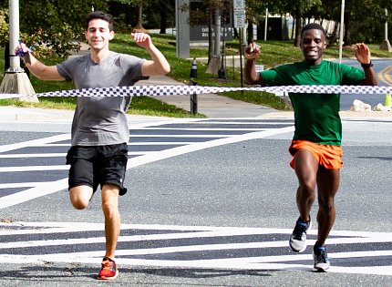 Two runners cross finish line simultaneously