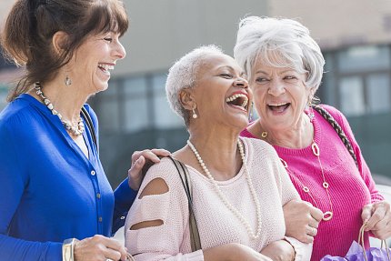 An older group of ladies share a laugh.