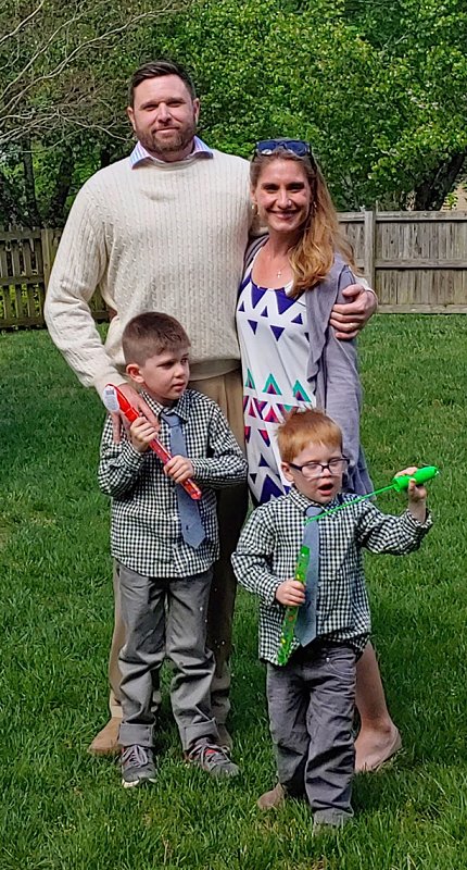 The Otterbacher family pose for a photo in a yard
