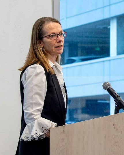 Dr. Nielsen speaks at a podium