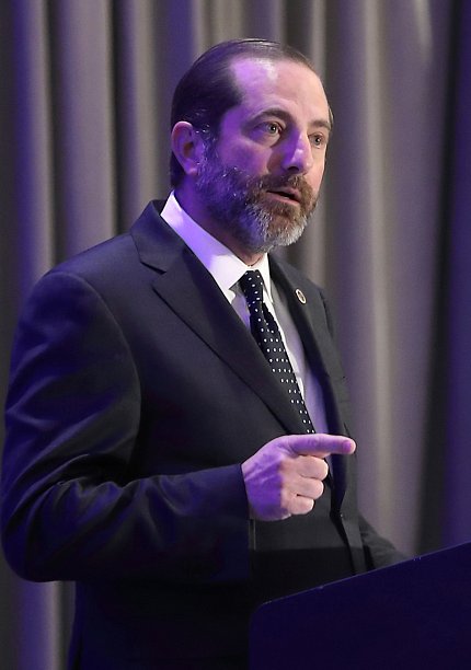 Azar stands speaking to audience