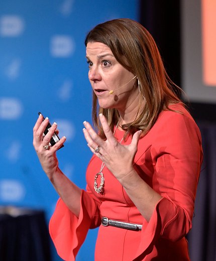 Karin Hurt with a blunt, serious expression holds up her hands.