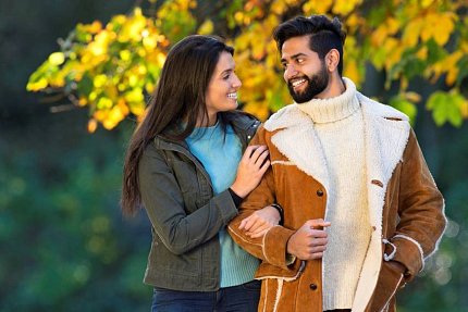 A woman holds a man's arm
