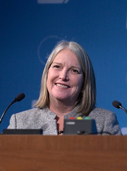 Dr. Stone smiles at the podium.