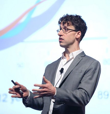 Dr. Minikel speaks on stage.