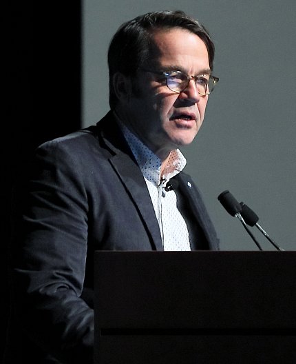 Dr. John Tisdale at podium