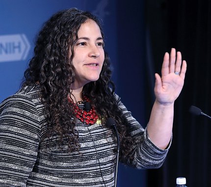 Santos stands at podium with hand raised