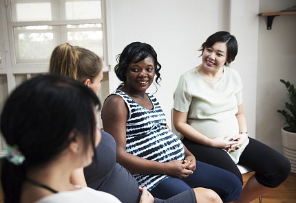 Four pregnant mothers speak to each other