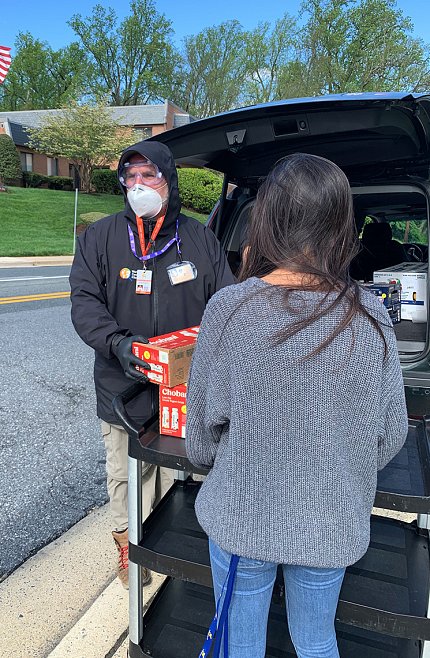 Andrés at trunk of car with supplies