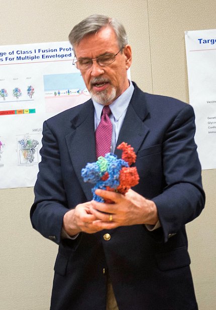Dr. Graham holds up a 3D model of a flu virus