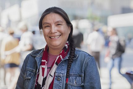 Native American woman smiles into camera