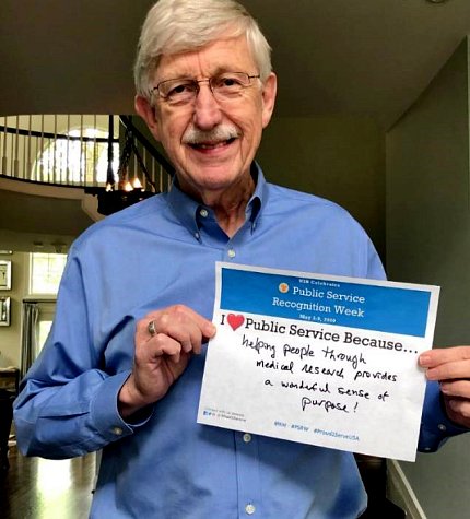 Collins holds sign about why he hearts public service.