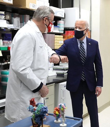 Graham and President Biden bump elbows.