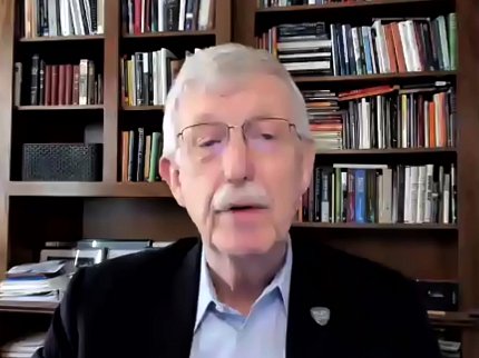 Screenshot of Collins's head and shoulders with shelves of books in background