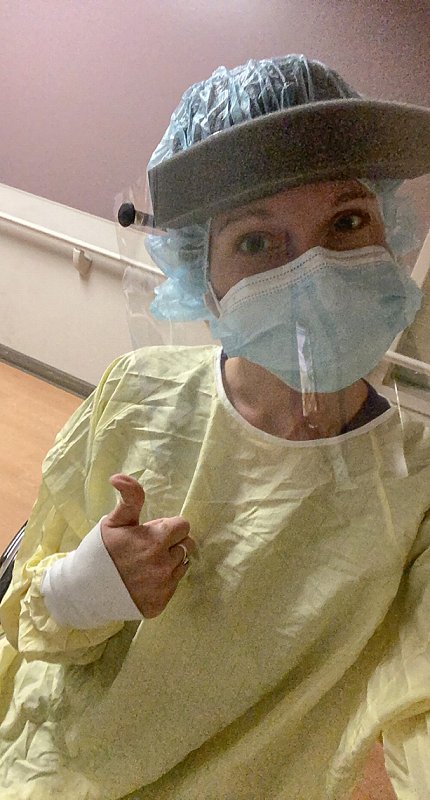 Mason gives a thumbs up while wearing PPE