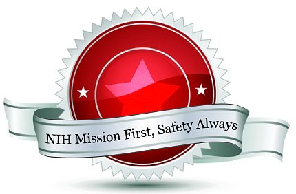 A red circular seal with two stars and surrounded by white trim has a ribbon that reads: NIH Mission First, Safety Always