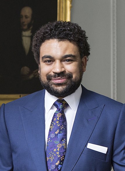 Portrait of Dr. Alexandre White, in museum in front of a painting