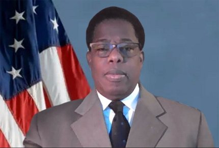 Cotton standing beside U.S. flag