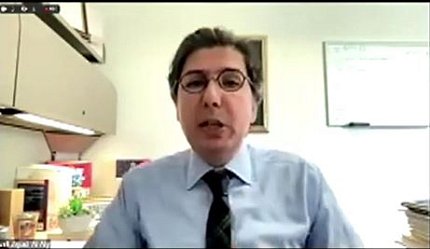 Dr. Al-Aly speaks virtually from his office