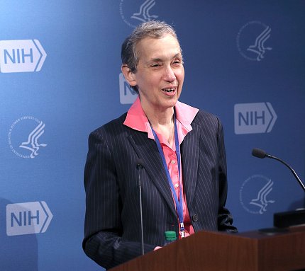 Schor speaks from a podium 