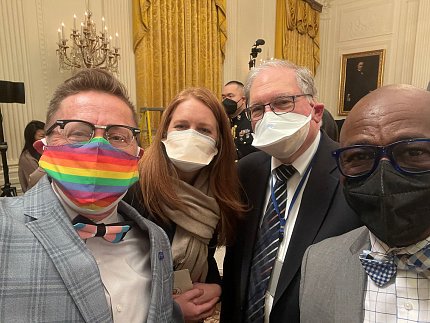 group shot of four individuals in face masks