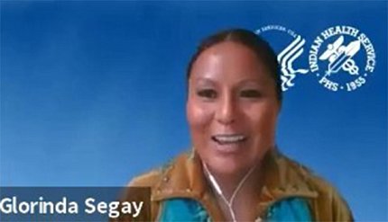 A screen shot of Segay in front of a blue background with HHS, IHS logos