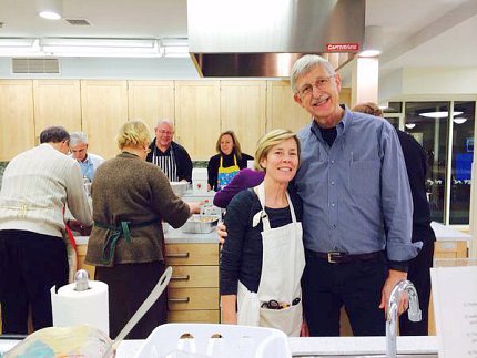 Baker and Collins, in kitchen of Children's Inn, with other staff behind them at counters