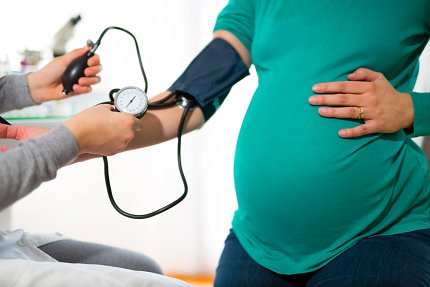 pregnant woman having her blood pressure checked