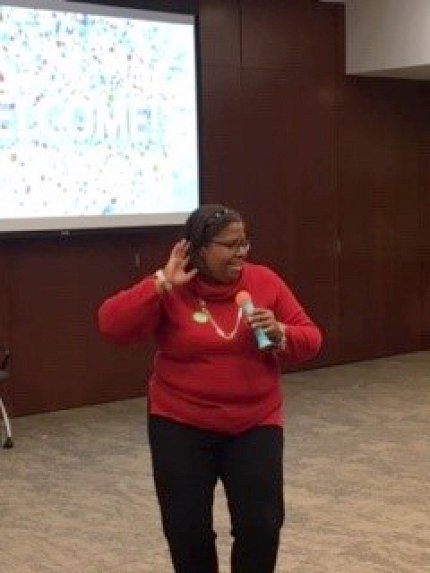 Holliday with microphone in hand