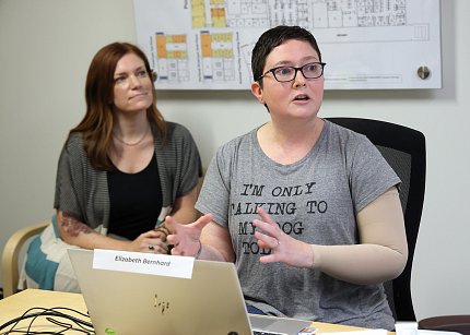 Bernhard presents, seated in front of a laptop, with Smith in background.