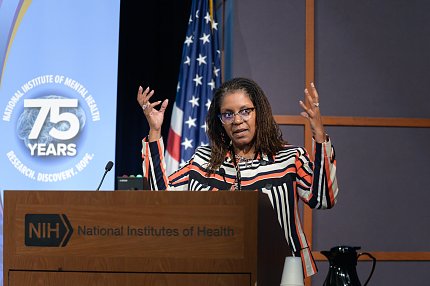 Dr. Lincoln speaks at a podium. 