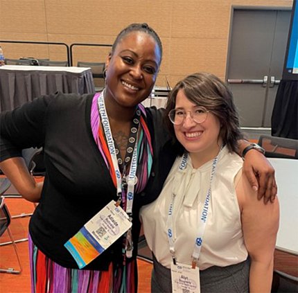 A smiling Holloway poses with a workshop participant.