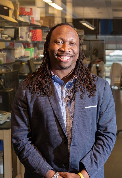 Platt smiles, with lab behind him