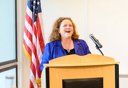 Norris smiles standing at a podium