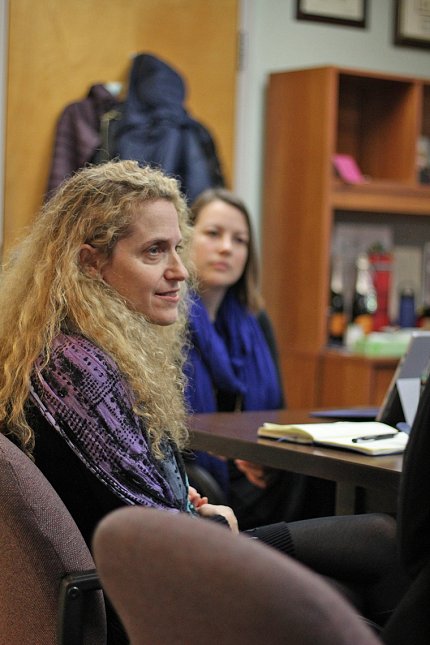 Stroud and a colleague sit at a conference table 