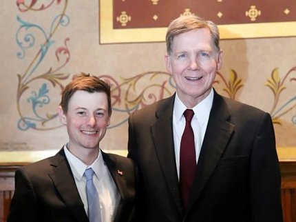 Andrew Lee and Dr. Linehan in suits pose together.