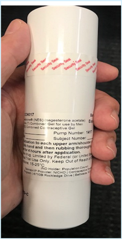 Hand holding a white bottle of NES/T gel