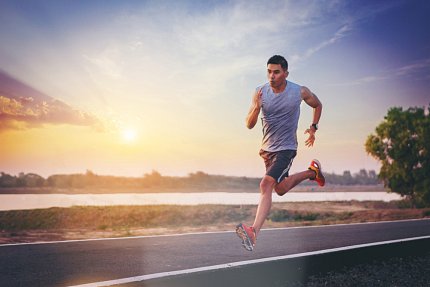 Man in sleeveless shirt and shorts running