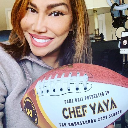 Fogle selfie with a football that reads Chef YaYa