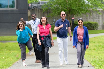 Group of smiling walkers in colorful clothes on the route