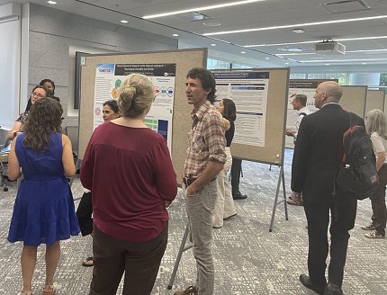 Attendees mingle during a poster session