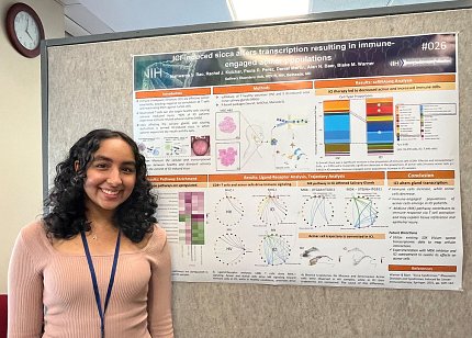 Rao stands next to her scientific poster