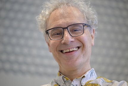 A smiling, bespectacled Ambros.