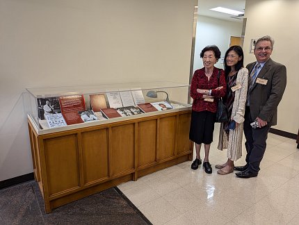 Whang-Peng and her family observe the display.