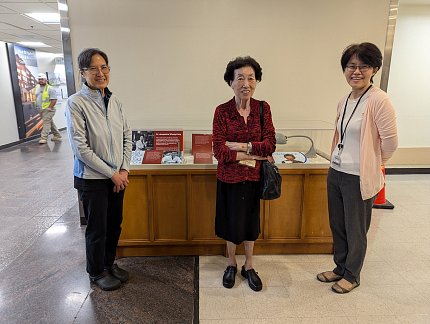 Wong, Whang-Peng and Tai smile for a photo in front of the display.